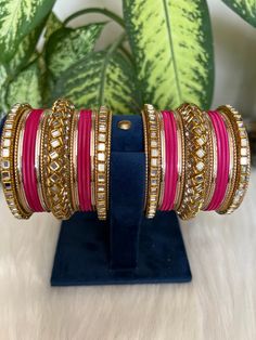 The perfect accessory for your special occasions, these Hot pink    and Golden Color Bangles feature Kundan and Stone detailing. Crafted with copper, these bangles are sure to add a touch of elegance and glamour to your look. Features: * Copper material *  kundan  detailing *  Hot pink  and Golden Color * Size: 2.6,2.8,2.10 Golden Saree, Copper Material, Bangle Set, Golden Color, Bangle Bracelets, Special Occasion, Hot Pink, Bangles, Jewelry Bracelets