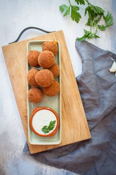 some food is sitting on a wooden tray