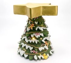 a decorated christmas tree with an ax on top and lights around the base, against a white background