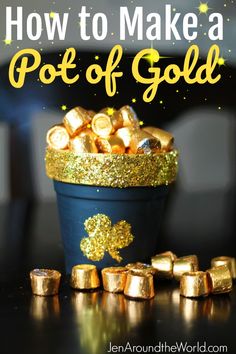 a pot filled with gold foil next to some chocolates