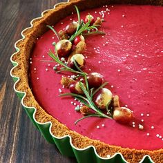 a red dessert with cranberry sauce and garnished with sprigs