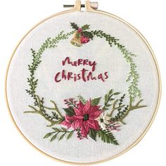 a christmas wreath with poinsettis and the words merry christmas