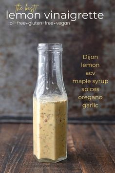 lemon vinaigrette in a glass bottle on a wooden table with text overlay