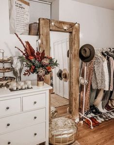 a closet with clothes, hats and other items on the floor next to a dresser