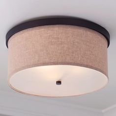 a light that is on the ceiling in a room with white walls and flooring