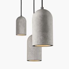 three concrete pendant lights hanging from the ceiling