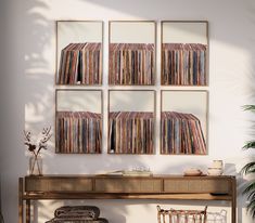 a room with a table, chair and wall mounted records on the wall above it