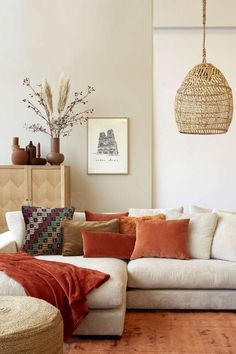 a living room filled with lots of furniture and decor on top of a hard wood floor