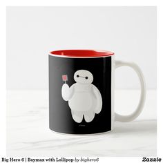 a black and red coffee mug with a cartoon character holding a flower in its hand