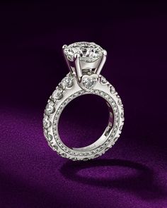 a diamond ring on a purple background