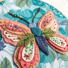 an embroidered butterfly sitting on top of a table