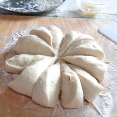 a wooden table topped with sliced up dough