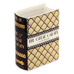 the great gatsby book is shown in gold and black, with an ornate design on