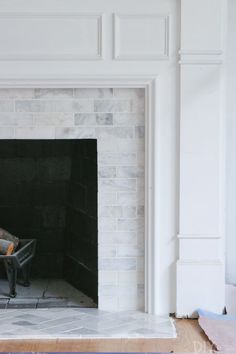 a man sitting in a chair near a fire place