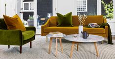 a living room with two green couches and a coffee table in front of it