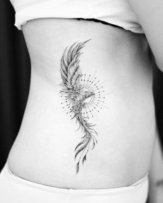 a woman's stomach with a bird tattoo on it