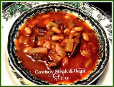 cowboy steak and bean stew in a black and white bowl on a floral patterned plate