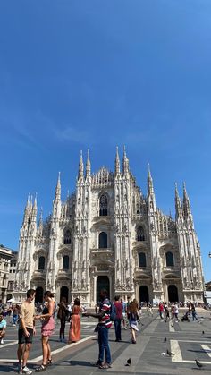 people are standing in front of the cathedral