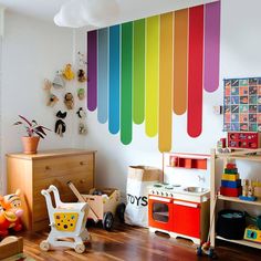 a child's play room with rainbow painted on the wall