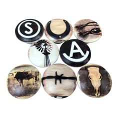 six different types of buttons with animals and letters on them, all in black and white