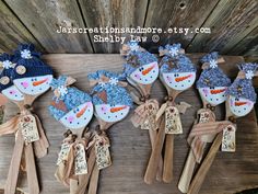 snowmen and carrots decorated on wooden spoons