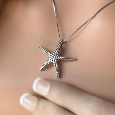 Catch a shooting star with our "Hoku" Starfish Pendant - crafted in .925 Sterling Silver or Gold Plated. Textured to mimic the look of a real starfish, it sparkles when it moves with you. Clever bale design is integrated into the pendant. This special is an 18 inch adjustable chain. "Hoku" Starfish Pendant Textured to mimic the look of a real starfish Clever bale design integrated into pendant Available in .925 Sterling Silver or Gold Plated Special matching 18 inch adjustable chain. White Gold Sterling Silver Starfish Jewelry, Sterling Silver Starfish Charm Jewelry, Ocean-inspired Silver Star Jewelry, Ocean-inspired Star Shaped Silver Jewelry, Silver Starfish Charm Jewelry, Silver Starfish-shaped Jewelry Gift, Silver Starfish Jewelry For Gifting, Silver Starfish Jewelry For Gifts, Silver Starfish Jewelry As Gift