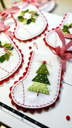 several christmas tree ornaments are hanging on a table