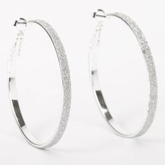 Make your ears sparkle with this pretty pair of hoop earrings. Hoops feature a silver-tone finish with shiny silver glitter accents all around the edges. Finish: Silver-tone Diamater: 40MM Closure: Snap back Material: Metal - Claire's Silver 40MM Thin Glitter Hoop Earrings Unicorn Gift Bags, Hoops With Charms, Claires Earrings, Triple Hoop Earrings, Thick Hoop Earrings, Hoop Earrings Silver, Glitter Earrings, Fashionable Jewelry, Pandora Silver