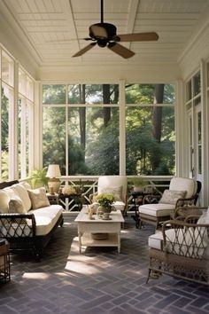 a screened porch with furniture and ceiling fan