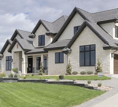 a large house with lots of windows and grass