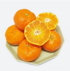 oranges are arranged on a white plate