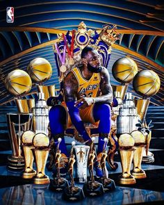 a man sitting on top of a golden chair surrounded by trophies and basketballs in front of him