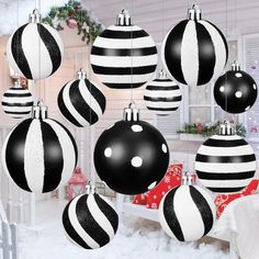 black and white christmas ornaments hanging from the ceiling