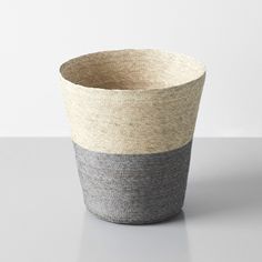 a gray and white basket sitting on top of a table