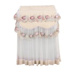 a white and pink bed skirt with flowers on it