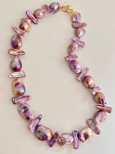 Item: Real Freshwater Baoroque Flameball Pearl 1 Strand Necklace Pearl Color: Pink Pearl quality: AAAA Party Jewelry With Round Baroque Pearls, Iridescent Polished Round Beads Jewelry, Iridescent Jewelry With Polished Round Beads, Party Jewelry With Beaded Baroque Pearls, Elegant Iridescent Round Bead Necklaces, Elegant Iridescent Necklace With Round Beads, Elegant Iridescent Beaded Necklace, Elegant Iridescent Beaded Necklaces For Jewelry Making, Multicolor Pearl Drop Beaded Necklace