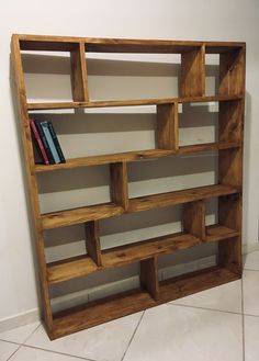 a bookshelf made out of wooden shelves on the floor