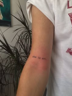 a person with a tattoo on their arm that says, one is art in black ink