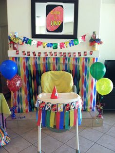 a baby's birthday party with balloons and streamers