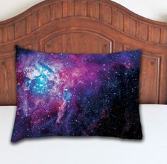 a bed with a wooden headboard and a pillow on it that has an image of the