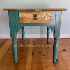 an old wooden table with drawers and knobs on the top is painted blue, yellow and brown