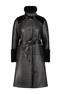 The Astrid is our modernized take on a classic trench coat suited for colder weather. Made from ultra-soft leather, statement cuffs, a distinctive buckled collar, and welt pockets, it brings a new level of sophistication to seasonal warmth, no matter what you're wearing or where you're going. Cinch it closed with the optional tie belt, or leave it open for a more relaxed look. Genuine leather and shearling Wind resistant Logo engraved button front closure Optional tie belt Buckle closure for col Black Leather Outerwear With Belted Cuffs, Leather Outerwear With Belted Cuffs For Business, Business Leather Outerwear With Belted Cuffs, Designer Black Outerwear With Belted Cuffs, Black Designer Outerwear With Belted Cuffs, Formal Leather Outerwear With Belted Cuffs, Designer Winter Outerwear With Belted Cuffs, Designer Leather Outerwear With Belted Cuffs, Winter Workwear Outerwear With Storm Flap