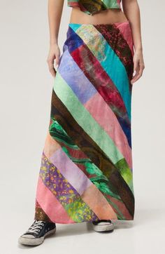 A patchwork of bold prints covers this flowy satin maxi skirt, adding major boho vibes to whatever look you pair it with. 37" length (size 8) Exclusive retailer Hidden side-zip closure 100% polyester Machine wash, line dry Imported Spring Green Patchwork Maxi Skirt, Hippie Multicolor Maxi Skirt, Green Flowy Patchwork Maxi Skirt, Flowy Patchwork Maxi Skirt For Summer, Green Flowy Maxi Skirt With Patchwork, Multicolor Mixed Print Skirt For Summer, Flowy Maxi Skirt With Floral Patchwork, Spring Floral Patchwork Maxi Skirt, Multicolor Silk Bohemian Skirt