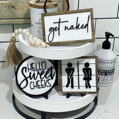 three tiered bathroom shelf with signs on it