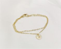 Our Double Chain Bracelet comes in silver, rose or gold chain options. Two sparkling chains for a minimal and chic look for everyday. Adorned with a tiny initial disc for that extra special touch. Makes the perfect gift too! D E T A I L S --Two layers of dainty link chain -8mm initial disc. -High quality 14kt gold filled, rose filled or sterling silver - not plated. -Premium lobster clasp LENGTH - Please select from the drop down selection. - Fits most sizing: 6.0 inches extra small 6.5 inches s Minimalist Charm Bracelet With Delicate Chain As Gift, Simple Adjustable Chain Bracelet Gift, Minimalist Charm Bracelet With Adjustable Chain Gift, Simple Adjustable Gold Bracelet For Gifts, Minimalist Adjustable Charm Bracelet For Gift, Minimalist Adjustable Charm Bracelet Gift, Personalized Dainty Gold Bracelet, Simple Hypoallergenic Chain Bracelet Gift, Delicate Chain Charm Bracelet Gift