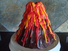 a volcano cake with red, yellow and orange icing