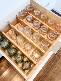 Glasses lined up in rows in a drawer divided by expandable bamboo drawer dividers Drawer Glass Storage, Glassware Drawer Storage, Kitchen Glassware Organization, Wine Glass Drawer Storage, Under Stove Drawer Organization, Organization For Drawers, Glassware Organization, Deep Kitchen Drawer, Deep Kitchen Drawer Organization