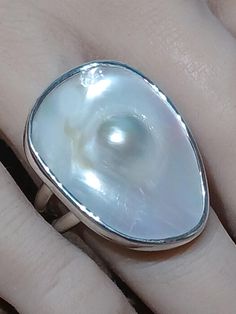 One of a kind, handcrafted, Blister Pearl and sterling silver ring. Size 9.5(one free sizing). Top measures about 30mm X 22mm. Artistic Rings With Polished Finish, Artistic Rings With Polished Finish For Gift, Artisan White Sterling Silver Ring, White Oval Dome Ring For Gift, White Oval Dome Ring Gift, Silver Pearl Ring With Polished Finish For Gift, Unique Oval Pearl Ring In Sterling Silver, Artistic Silver Round Rings, Unique Polished Pearl Ring Gift