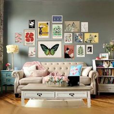 a living room filled with furniture and lots of pictures on the wall above it's coffee table