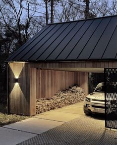 a car is parked in front of a wooden building with a metal roof and door